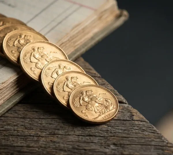 Gold sovereign coins arranged strategically with UK economic indicators representing inflation hedge investment